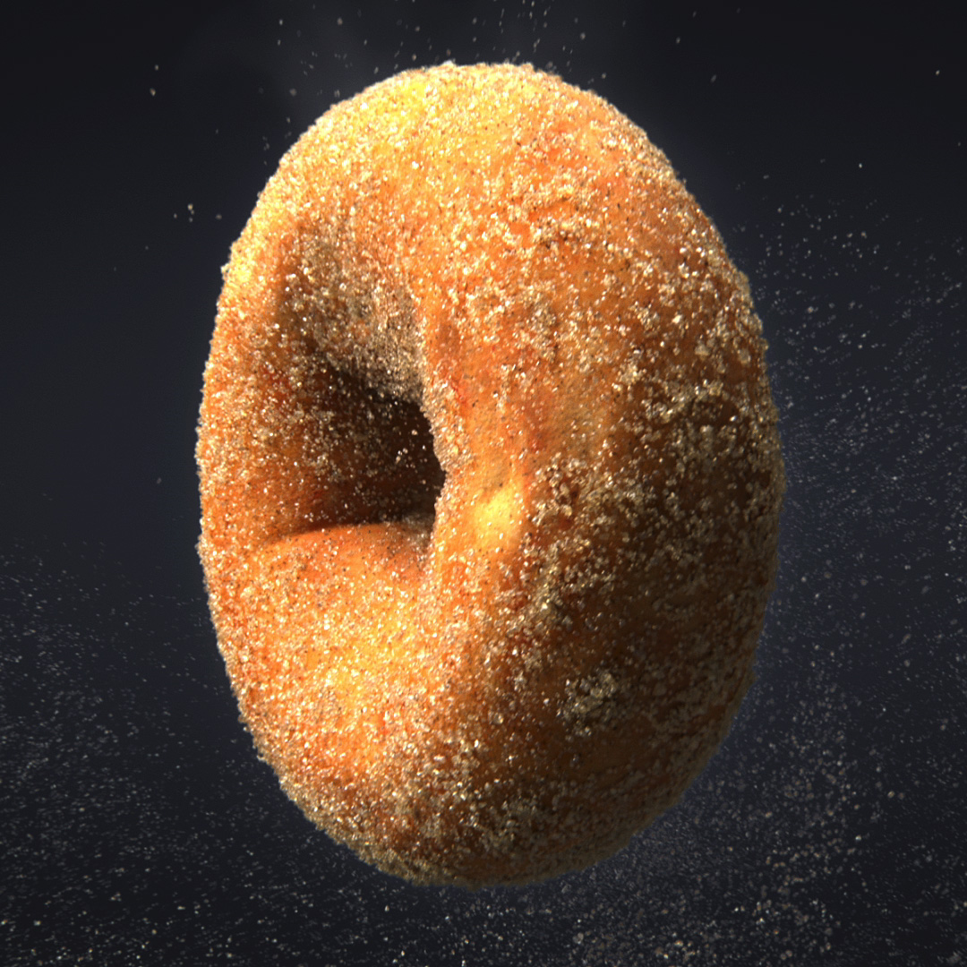 A cinnamon donut floating mid-air on a dark grey background. There are sugar and cinnamon particles floating around it.