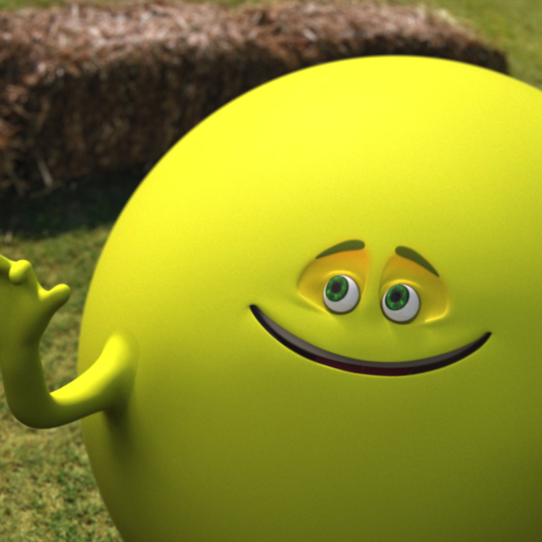 Closeup of an animated yellow ball with arms and a face. It is smiling with its arm raised. There is a hay bale in the background.